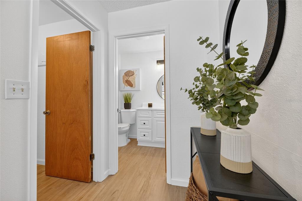 13035 Santee Street Spring Hill, FL 34609 - Photo 11 of 39 a view of a hallway with wooden floor and a potted plant