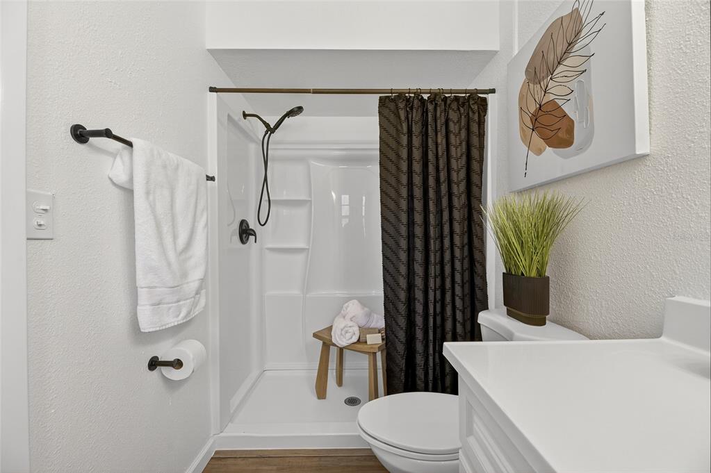 13035 Santee Street Spring Hill, FL 34609 - Photo 13 of 39 a bathroom with a toilet and shower