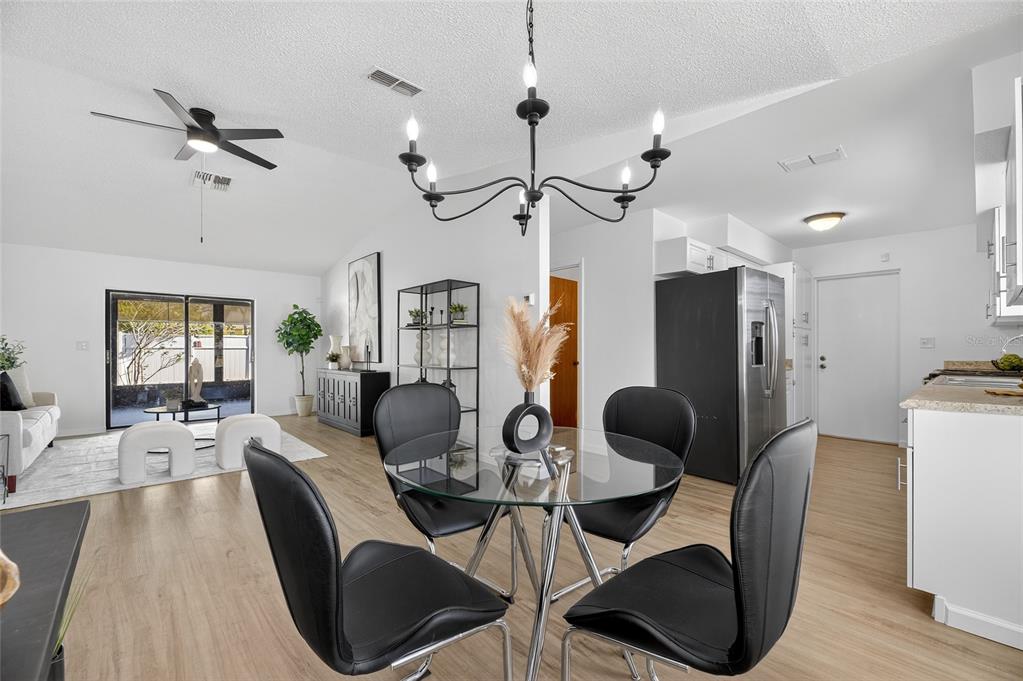 13035 Santee Street Spring Hill, FL 34609 - Photo 16 of 39 a view of a dining room with furniture window and wooden floor