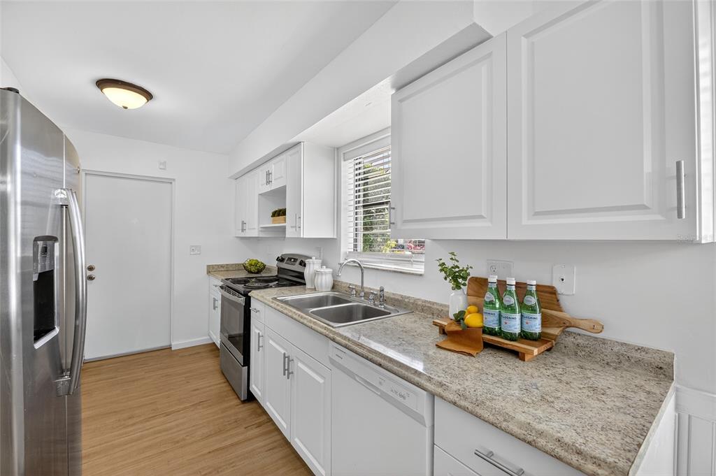 13035 Santee Street Spring Hill, FL 34609 - Photo 18 of 39 a kitchen with a sink appliances and cabinets