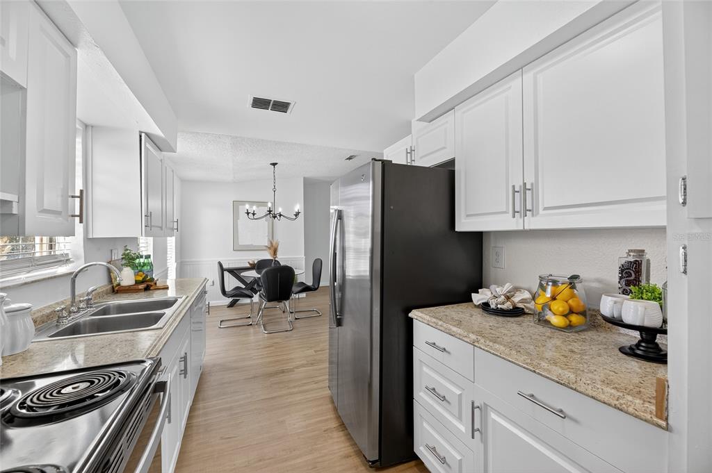 13035 Santee Street Spring Hill, FL 34609 - Photo 20 of 39 a kitchen with granite countertop lots of counter top space and stainless steel appliances