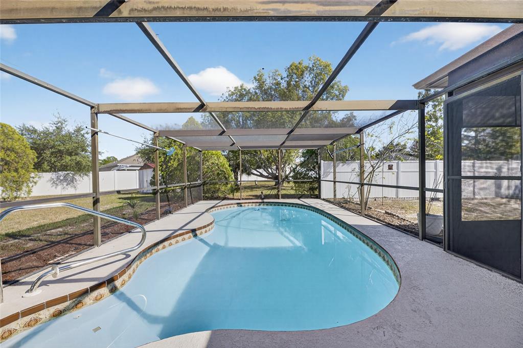 13035 Santee Street Spring Hill, FL 34609 - Photo 2 of 39 a view of a swimming pool with a patio