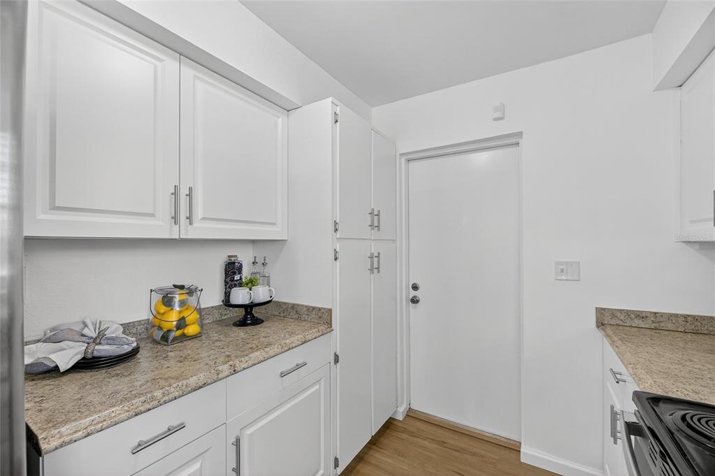13035 Santee Street Spring Hill, FL 34609 - Photo 22 of 39 a kitchen with stainless steel appliances granite countertop white cabinets and a refrigerator