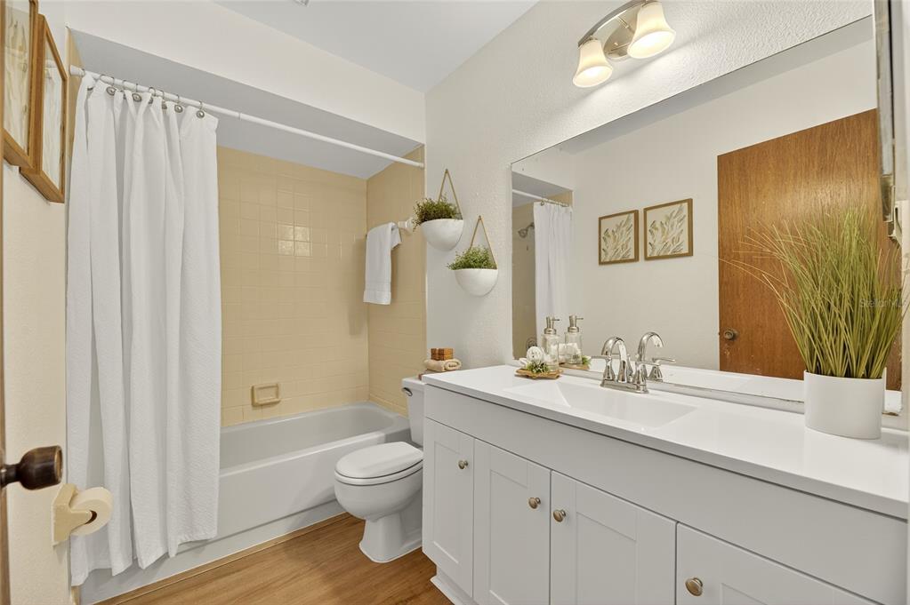 13035 Santee Street Spring Hill, FL 34609 - Photo 26 of 39 a bathroom with a granite countertop sink toilet a large mirror a vanity and shower