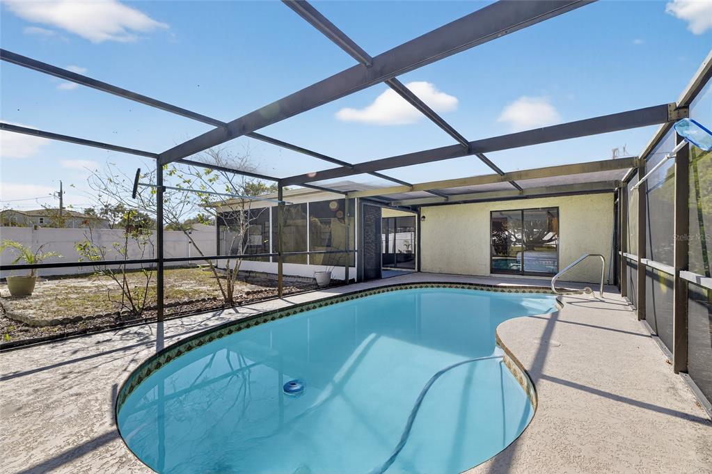 13035 Santee Street Spring Hill, FL 34609 - Photo 31 of 39 a view of a swimming pool with a patio