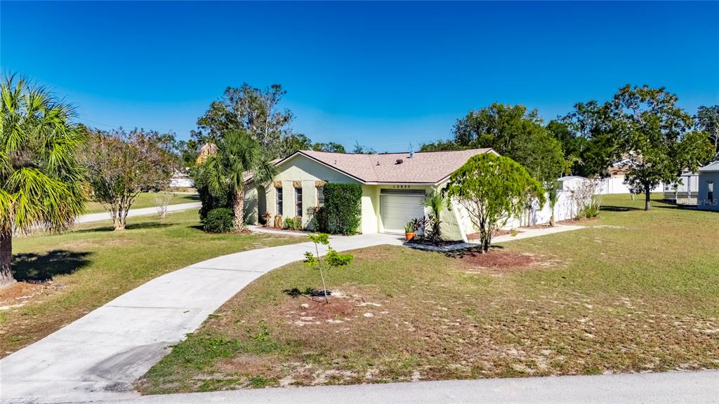 13035 Santee Street Spring Hill, FL 34609 - Photo 35 of 39 a view of a house with a yard and tree s