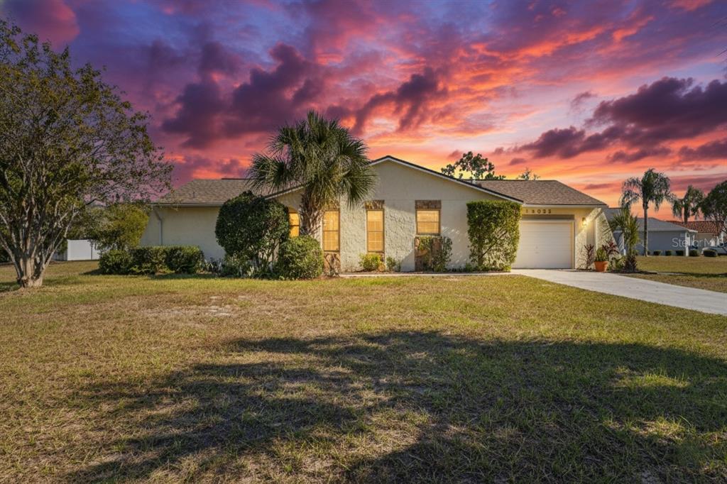 13035 Santee Street Spring Hill, FL 34609 - Photo 39 of 39 a yellow house with a yard