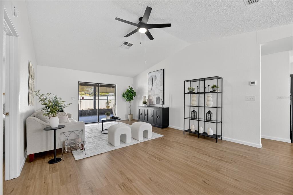 13035 Santee Street Spring Hill, FL 34609 - Photo 4 of 39 a living room with furniture a window and wooden floor