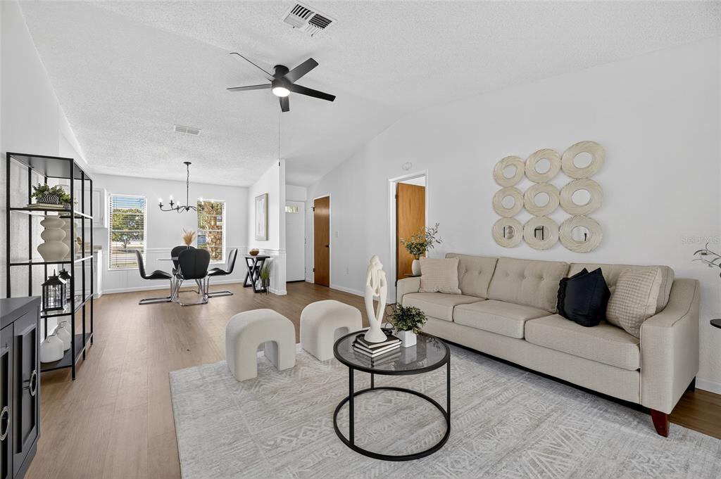13035 Santee Street Spring Hill, FL 34609 - Photo 5 of 39 a living room with furniture a couch and a chandelier