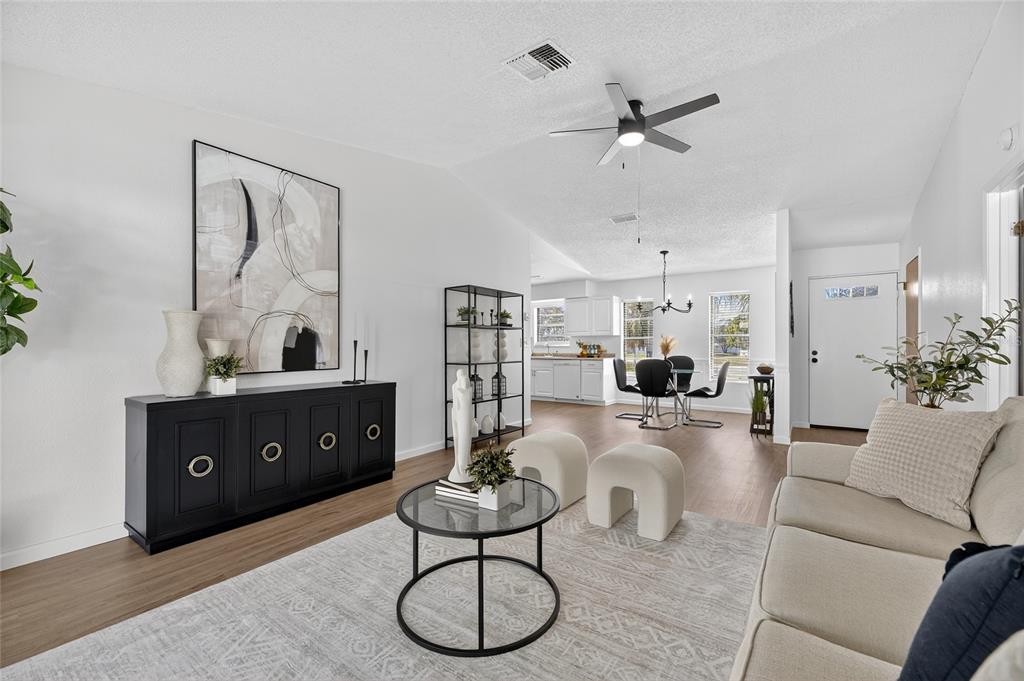 13035 Santee Street Spring Hill, FL 34609 - Photo 6 of 39 a living room with furniture a rug and white walls