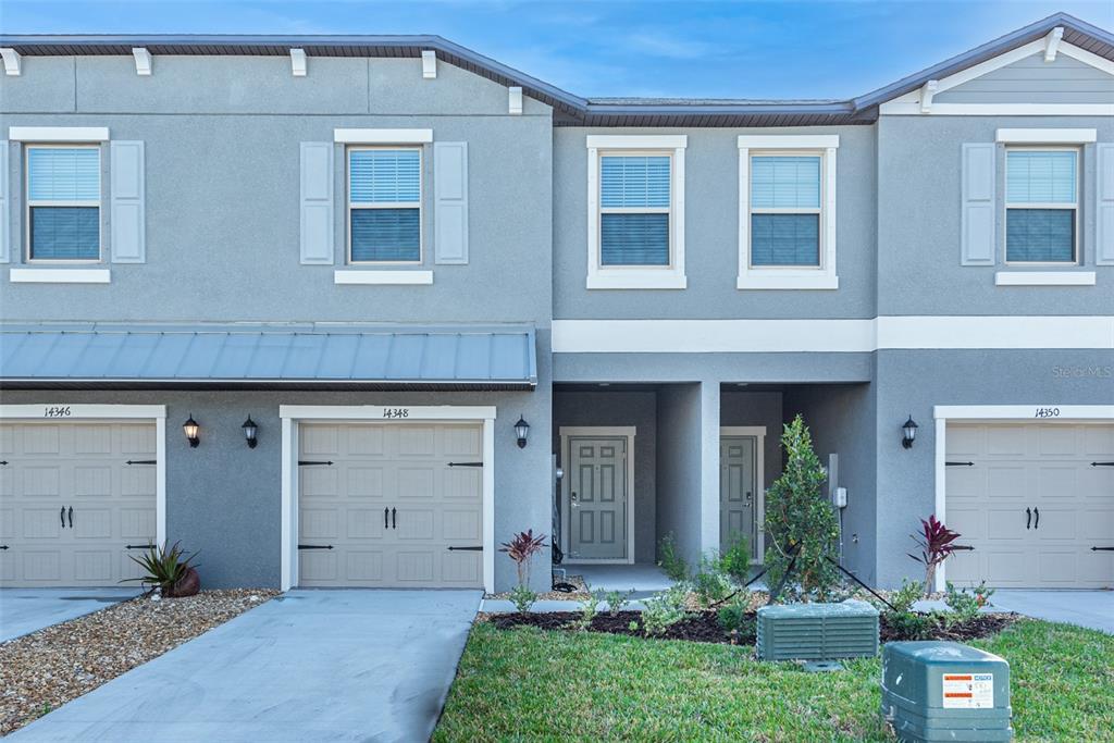 14348 Editors Note Street Ruskin, FL 33573 - Photo 1 of 29 a front view of a house with a yard