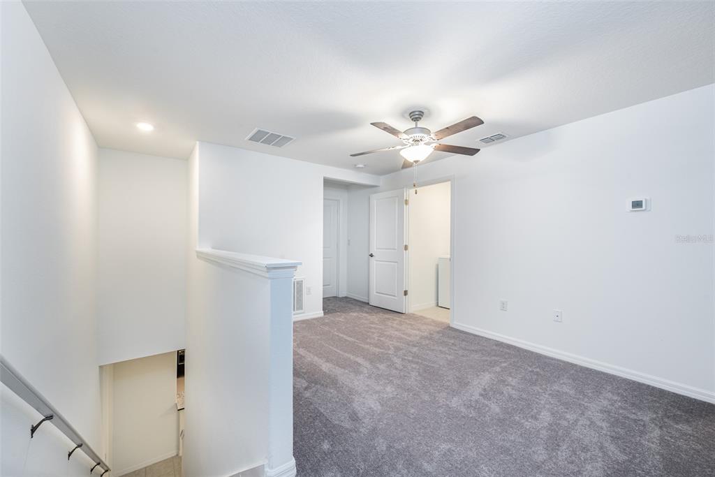 14348 Editors Note Street Ruskin, FL 33573 - Photo 12 of 29 a view of a livingroom with a ceiling fan and a chandelier fan
