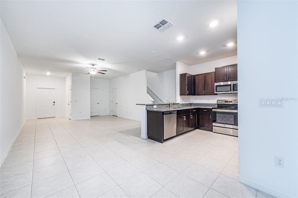 14348 Editors Note Street Ruskin, FL 33573 - Photo 5 of 29 a large kitchen with a large counter top appliances and cabinets