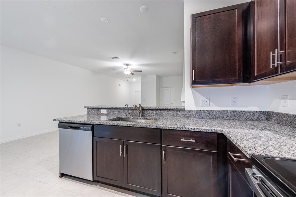 14348 Editors Note Street Ruskin, FL 33573 - Photo 6 of 29 a bathroom with a granite countertop sink and a mirror