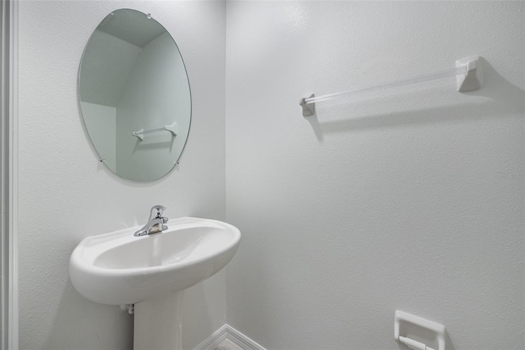 14348 Editors Note Street Ruskin, FL 33573 - Photo 10 of 29 a bathroom with a sink and a mirror