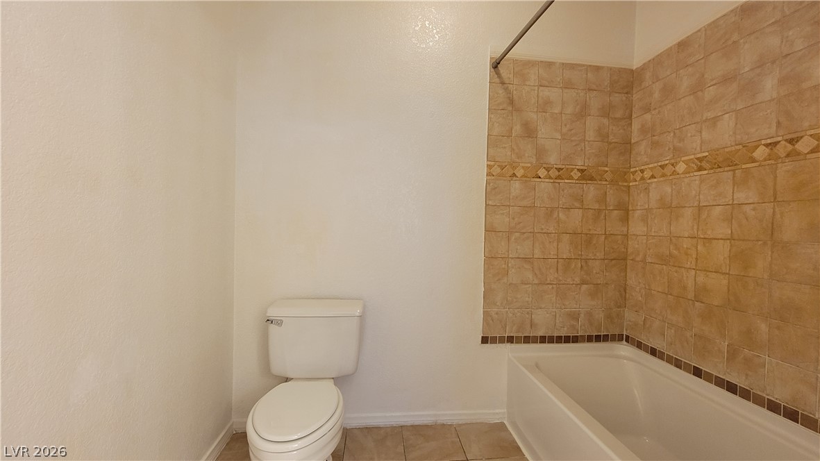 3320 South Fort Apache Road, Unit 111 Las Vegas, NV 89117 - Photo 7 of 12 A pristine bathroom features a classic tub-shower combination with decorative tile work.