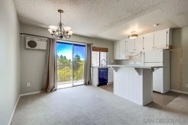 a view of a kitchen with a sink and refrigerator
