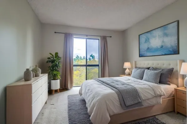 a bedroom with a large bed and a large window