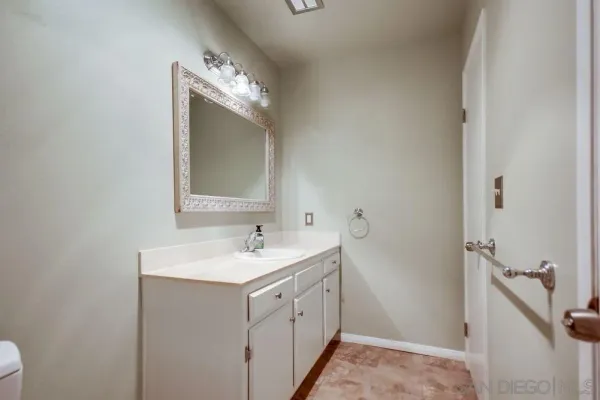 a bathroom with a double vanity sink and mirror