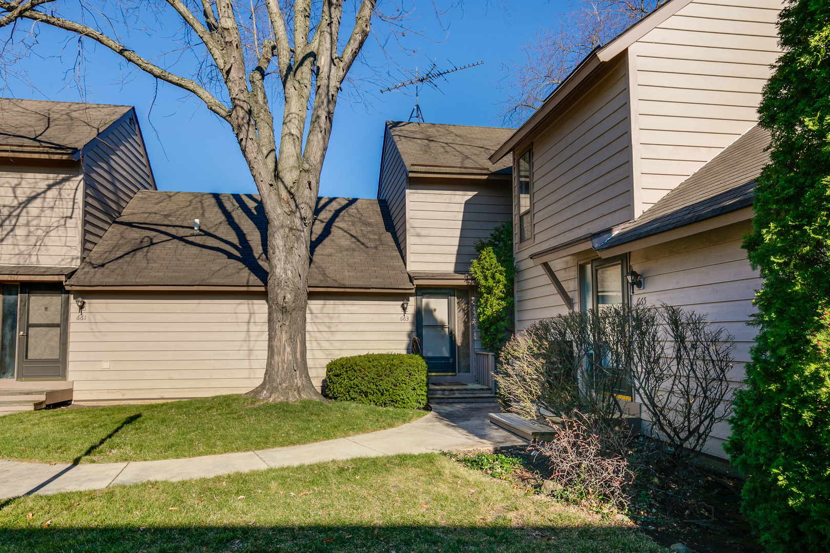 663 Beth Court Gurnee, IL 60031 - Photo 1 of 26 a front view of a house with a yard and potted plants