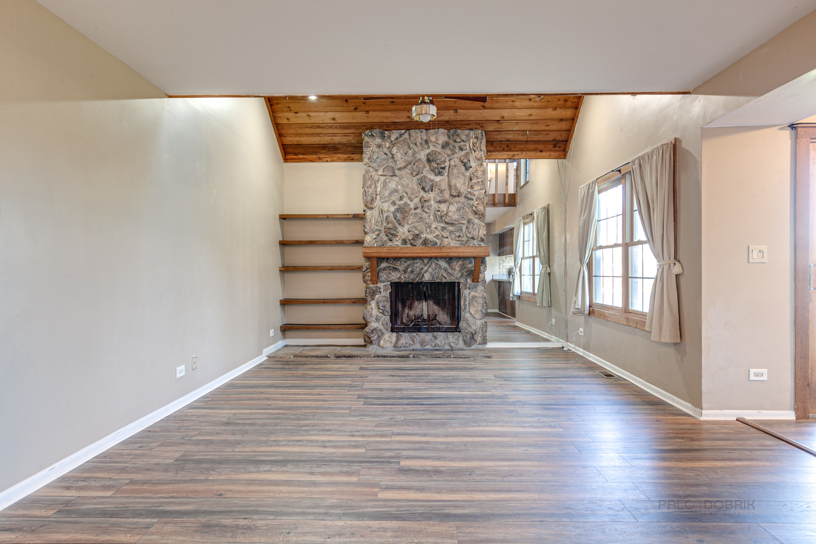 663 Beth Court Gurnee, IL 60031 - Photo 4 of 26 a view of empty room with wooden floor and fireplace
