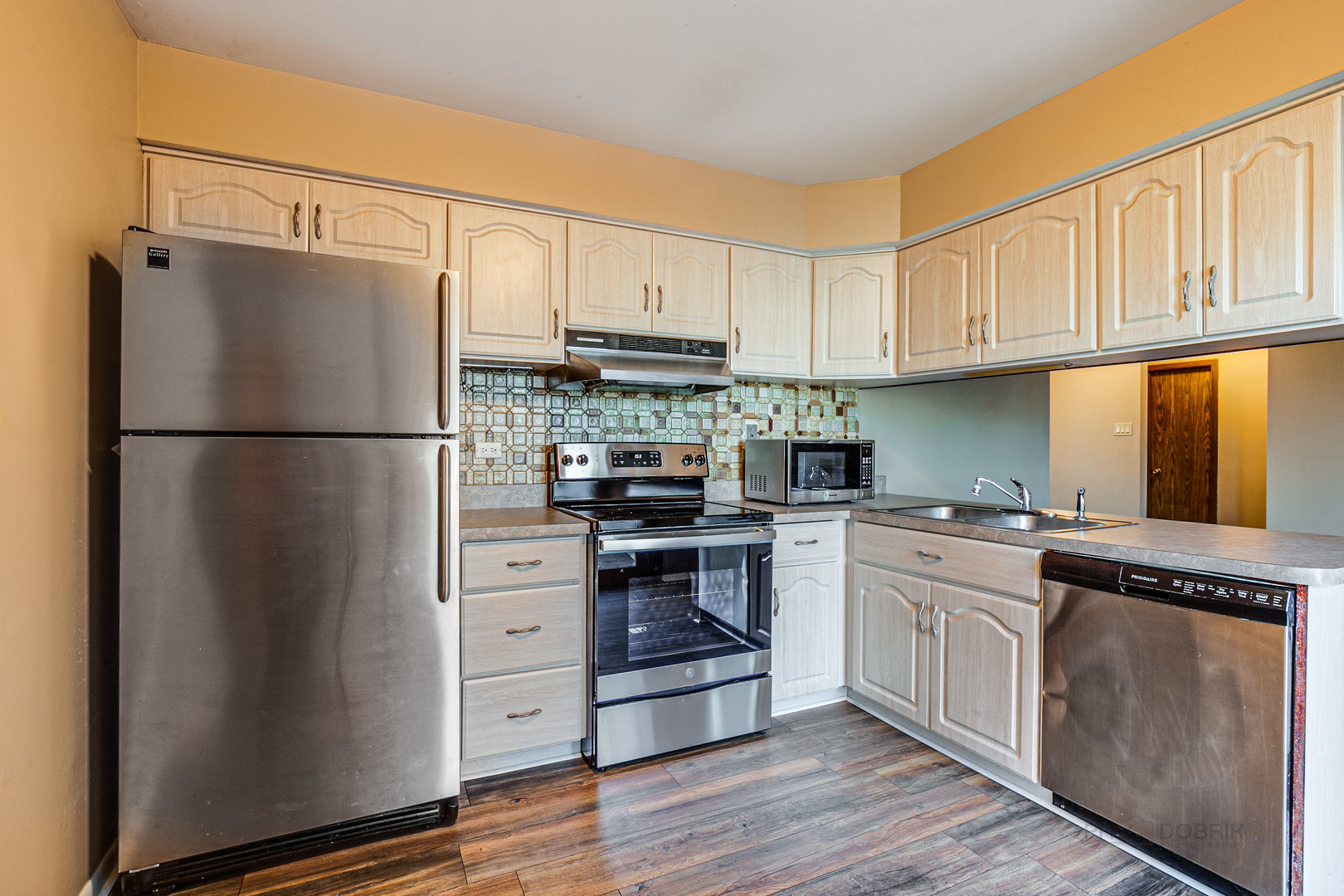 663 Beth Court Gurnee, IL 60031 - Photo 7 of 26 a kitchen with white cabinets and white appliances