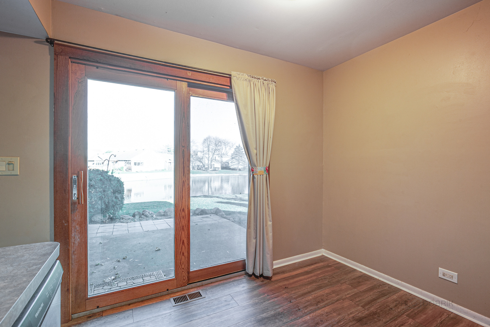 663 Beth Court Gurnee, IL 60031 - Photo 9 of 26 an empty room with wooden floor and windows