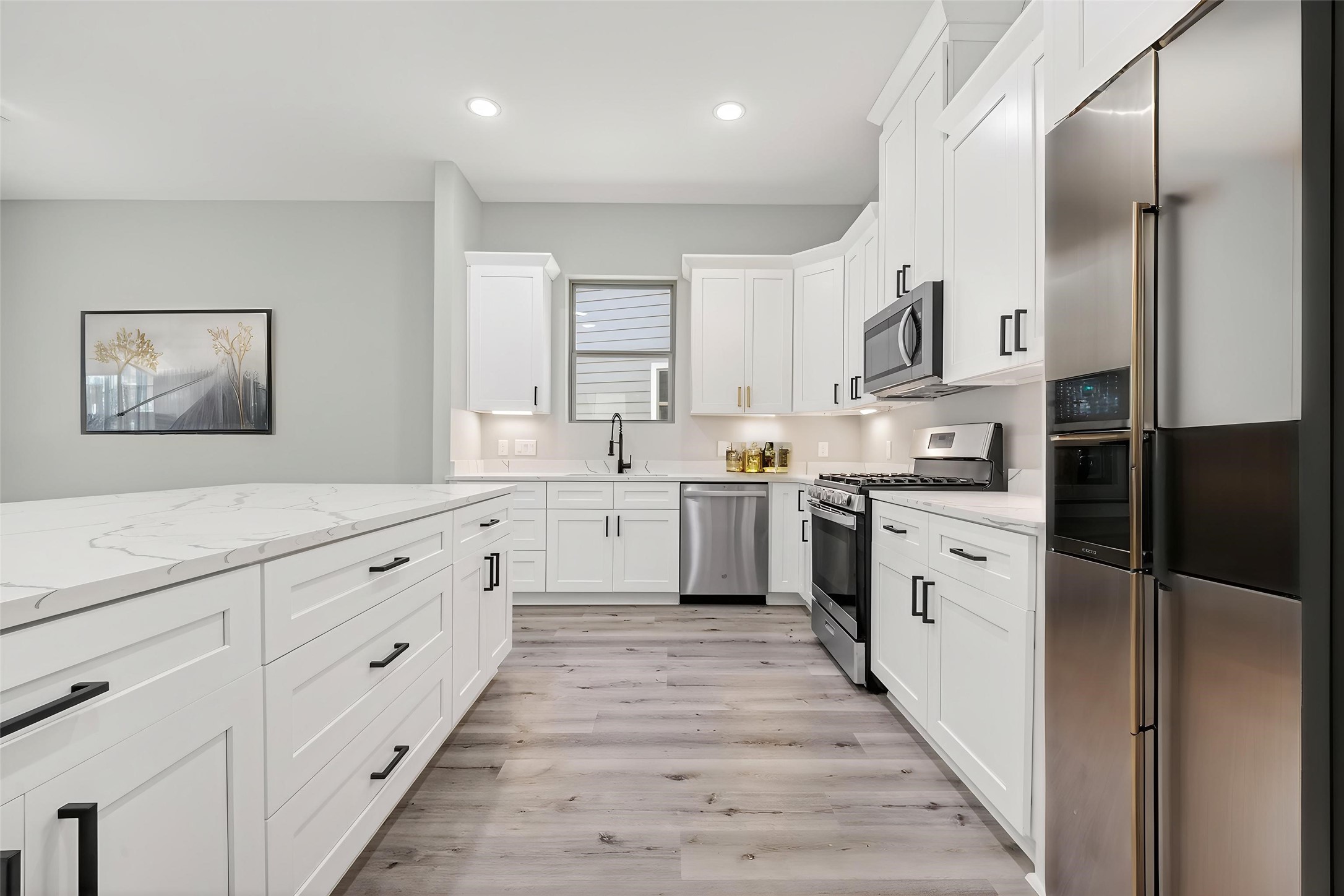 4906 Wunder Way Houston, TX 77069 - Photo 11 of 44 a kitchen with white cabinets and white appliances