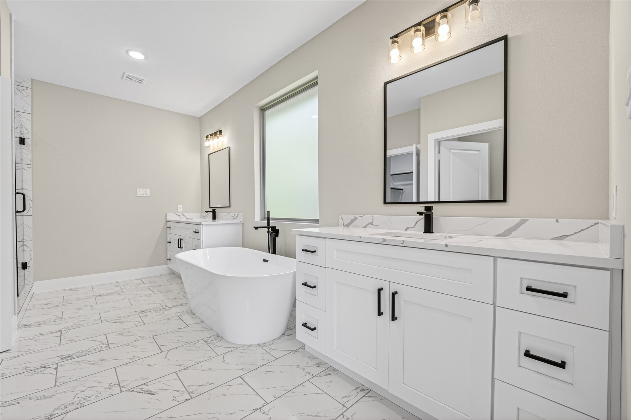 4906 Wunder Way Houston, TX 77069 - Photo 22 of 44 a bathroom with a double vanity sink mirror and bathtub