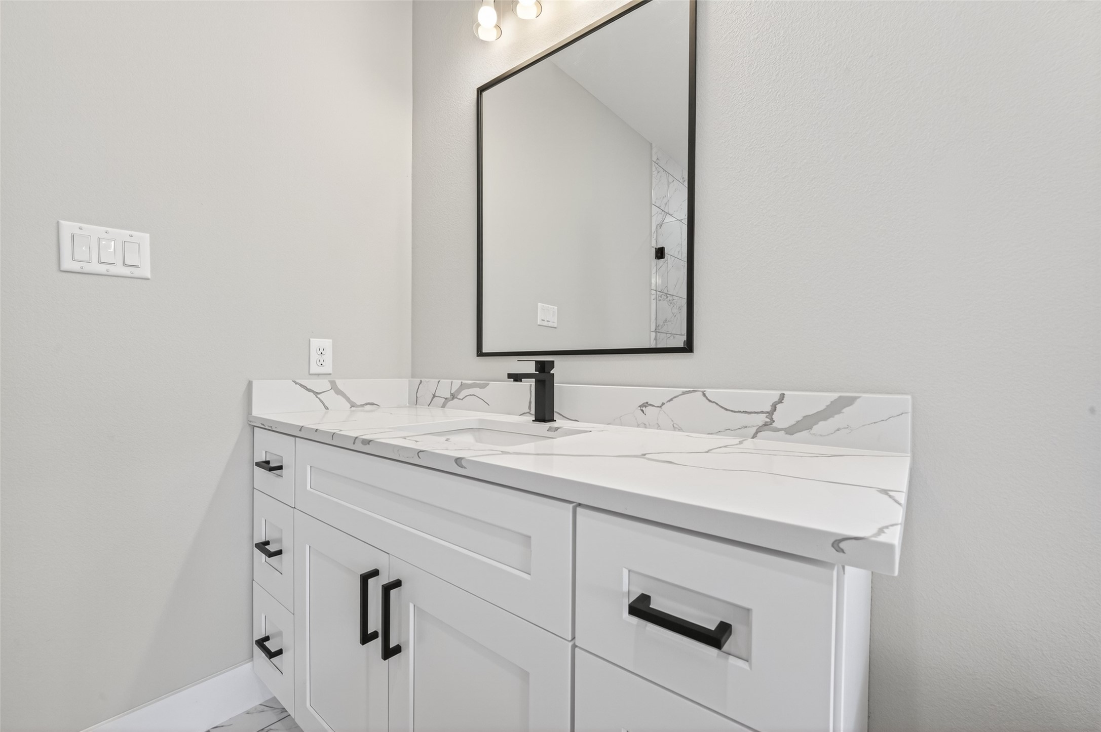 4906 Wunder Way Houston, TX 77069 - Photo 26 of 44 a bathroom with a granite countertop sink and a mirror