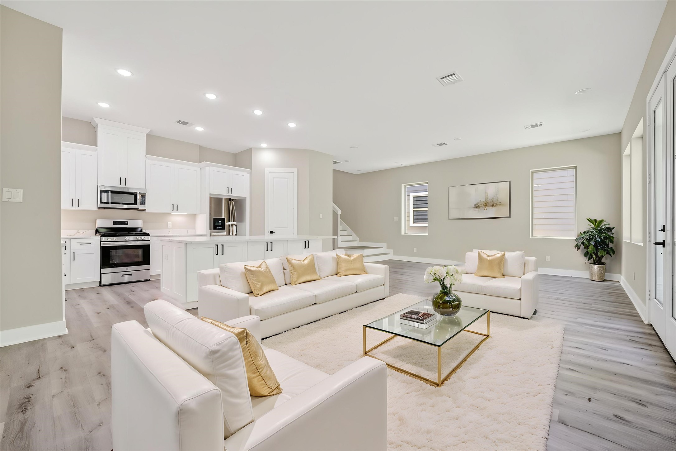 4906 Wunder Way Houston, TX 77069 - Photo 6 of 44 a living room with furniture kitchen view and a wooden floor