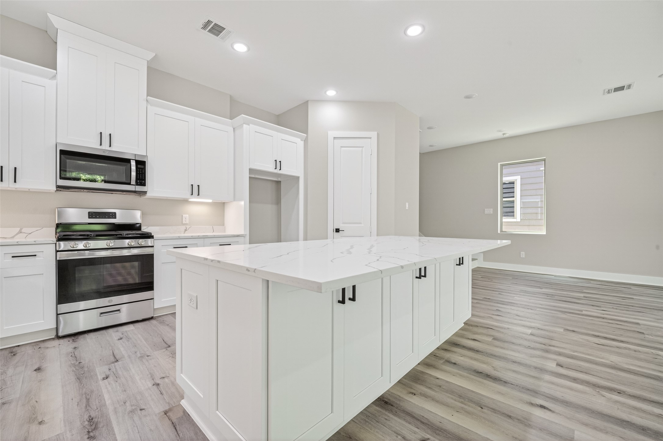 4906 Wunder Way Houston, TX 77069 - Photo 7 of 44 a kitchen with stainless steel appliances a stove a sink and a refrigerator