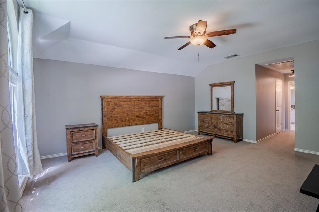 921 Carnegie Court Allen, TX 75002 - Photo 19 of 33 a bedroom with furniture and a chandelier