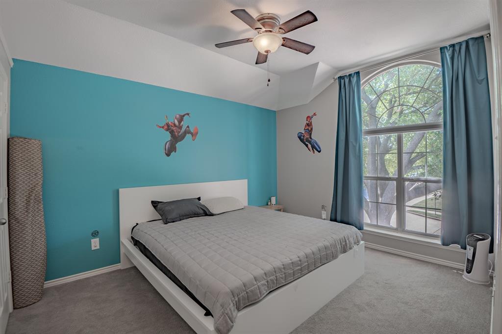 921 Carnegie Court Allen, TX 75002 - Photo 22 of 33 a bedroom with a large bed and a window
