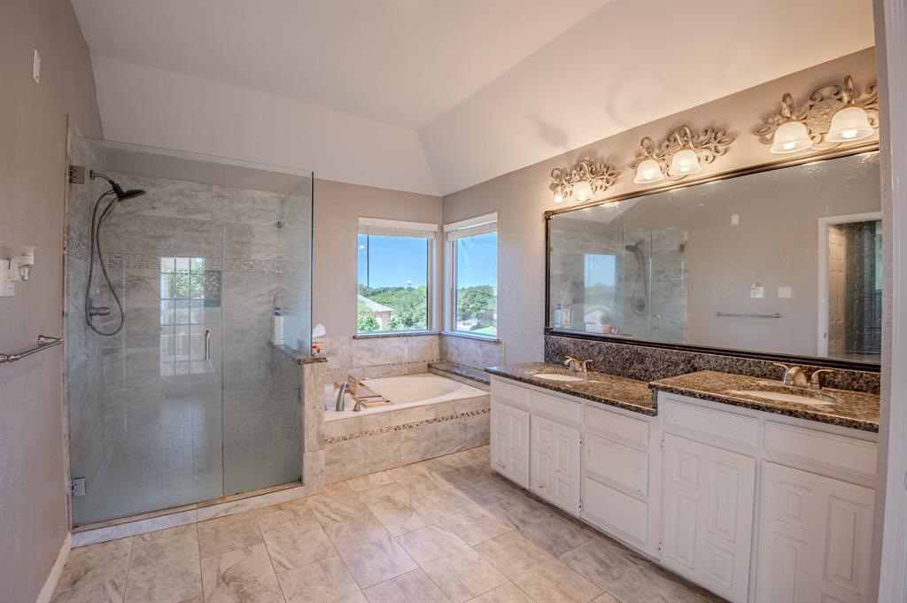921 Carnegie Court Allen, TX 75002 - Photo 26 of 33 a bathroom with a granite countertop sink mirror and bathtub