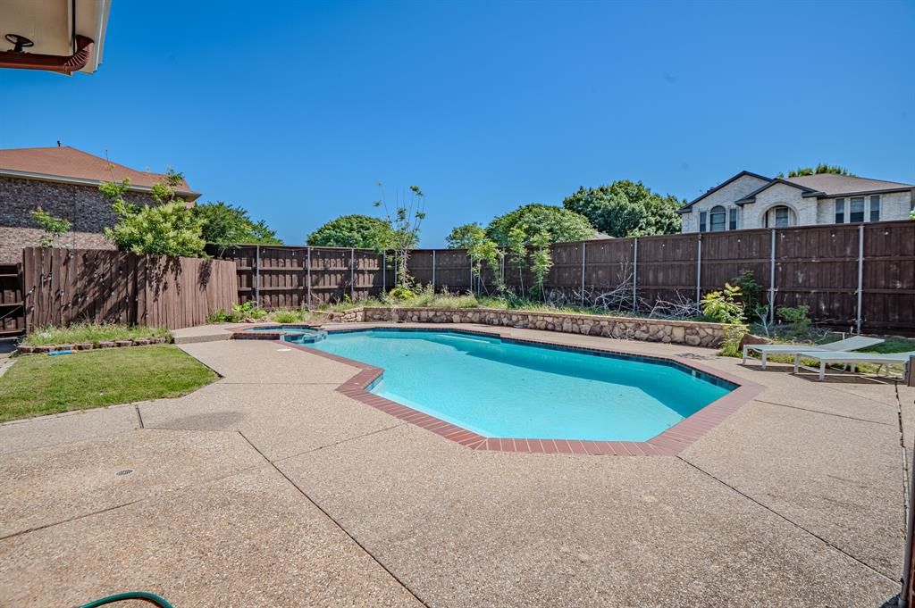 921 Carnegie Court Allen, TX 75002 - Photo 29 of 33 a swimming pool with outdoor seating and yard