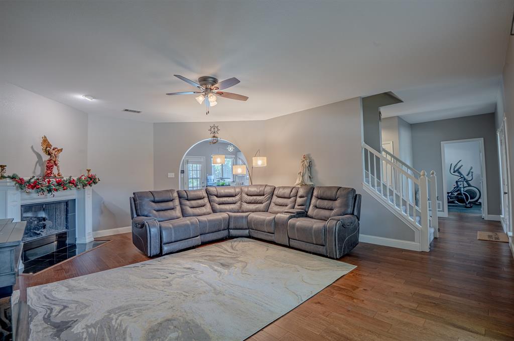 921 Carnegie Court Allen, TX 75002 - Photo 5 of 33 a living room with furniture a fireplace and a chandelier