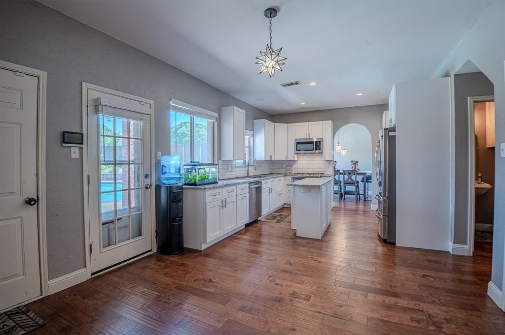 921 Carnegie Court Allen, TX 75002 - Photo 6 of 33 a view of a kitchen with furniture and wooden floor