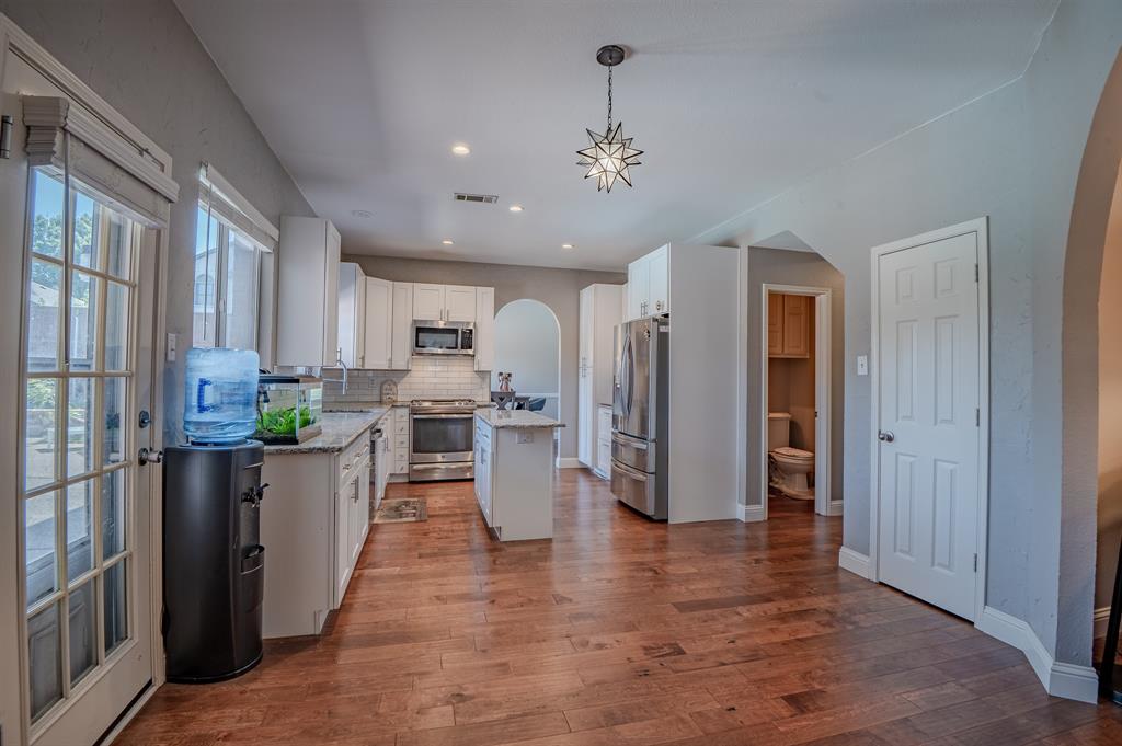 921 Carnegie Court Allen, TX 75002 - Photo 8 of 33 a view of a kitchen with refrigerator and wooden floor