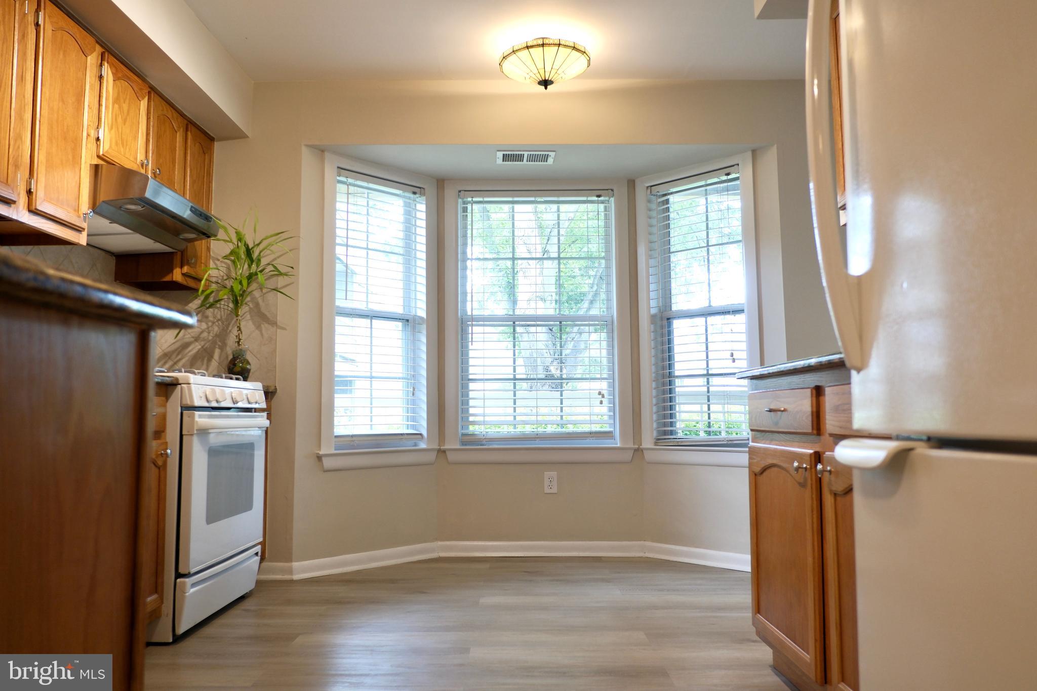 307 Trinity Court, Unit 4 Princeton, NJ 08540 - Photo 12 of 39 an empty room with wooden floor and windows