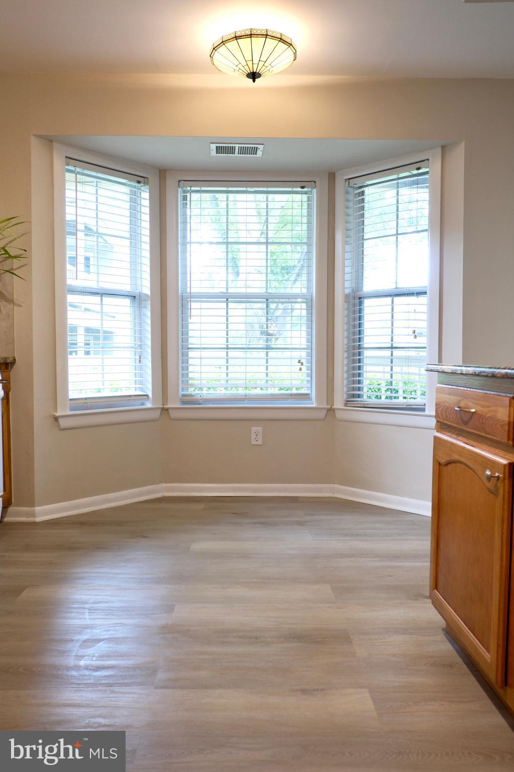 307 Trinity Court, Unit 4 Princeton, NJ 08540 - Photo 15 of 39 an empty room with wooden floor and windows