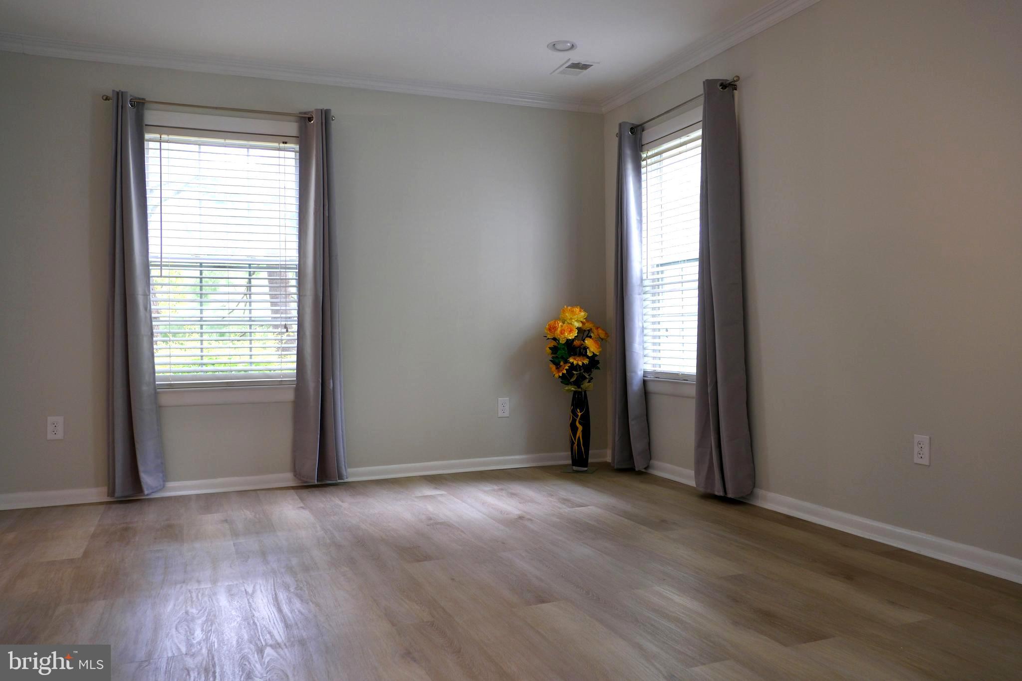 307 Trinity Court, Unit 4 Princeton, NJ 08540 - Photo 16 of 39 an empty room with wooden floor and windows