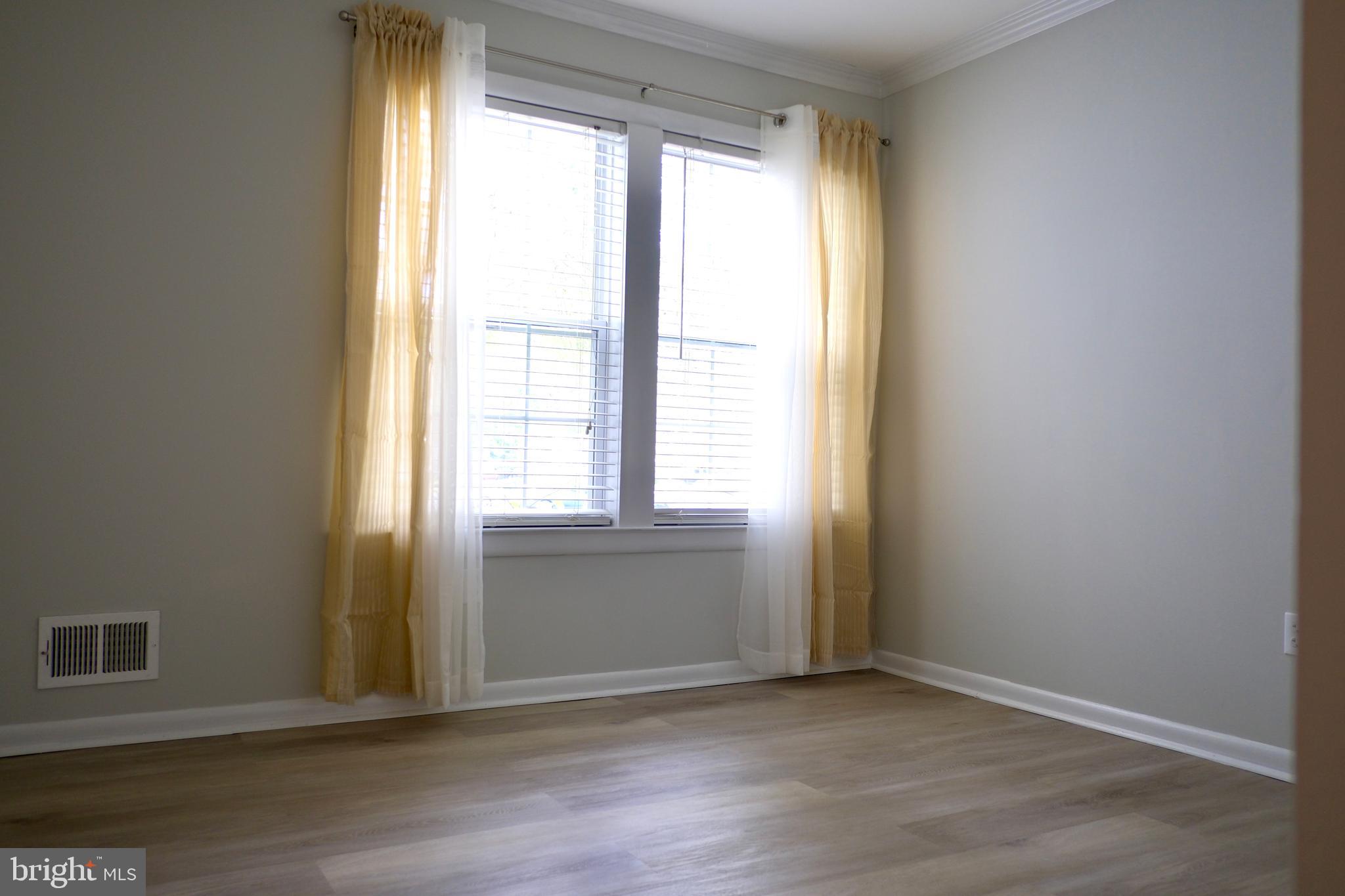 307 Trinity Court, Unit 4 Princeton, NJ 08540 - Photo 24 of 39 an empty room with wooden floor and windows