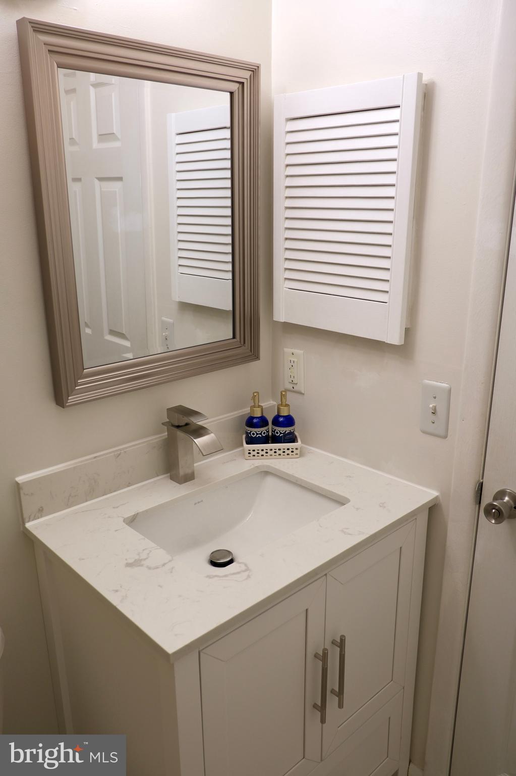 307 Trinity Court, Unit 4 Princeton, NJ 08540 - Photo 28 of 39 a bathroom with a sink and a mirror