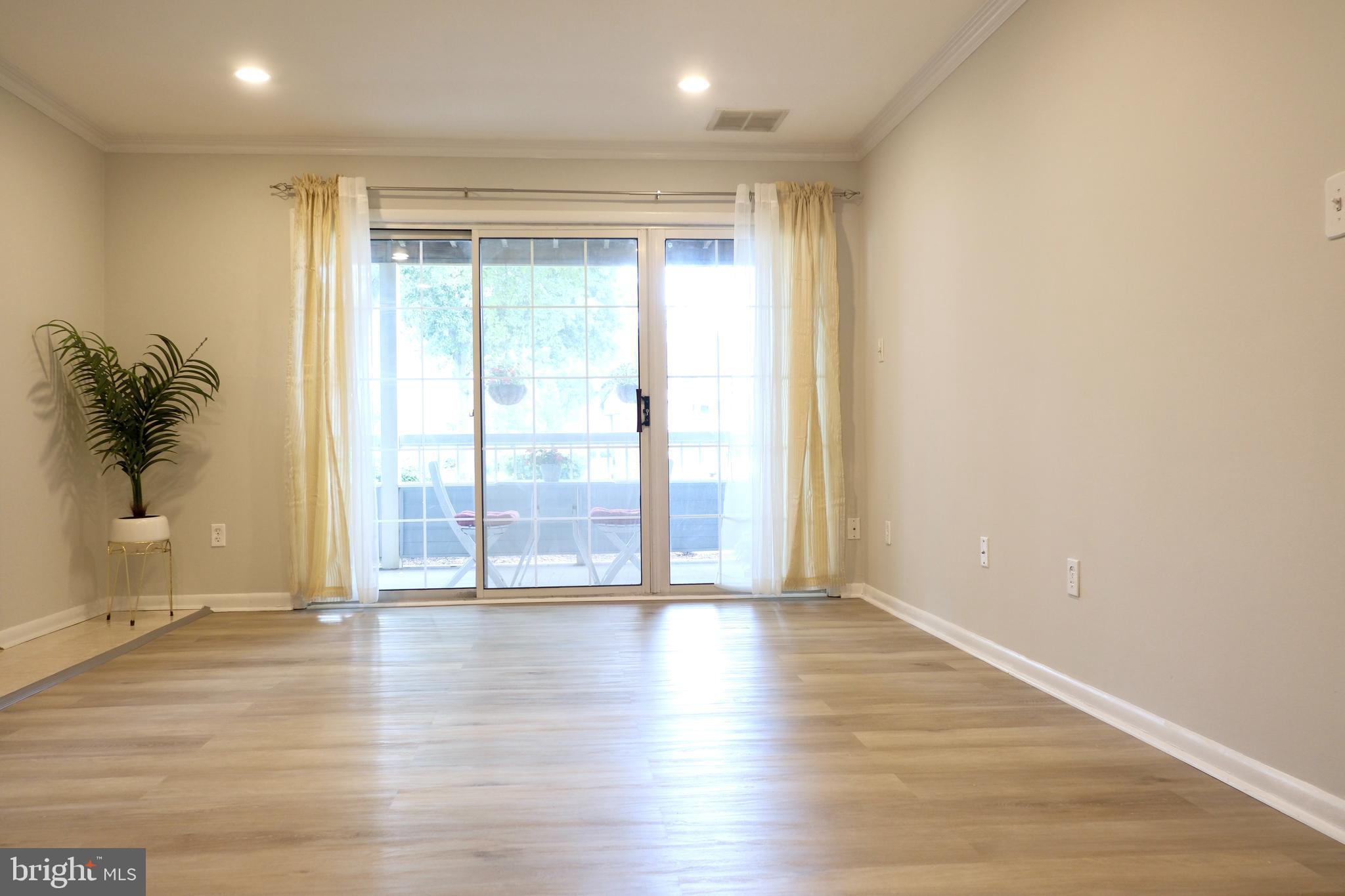 307 Trinity Court, Unit 4 Princeton, NJ 08540 - Photo 7 of 39 a view of an empty room with wooden floor and a window
