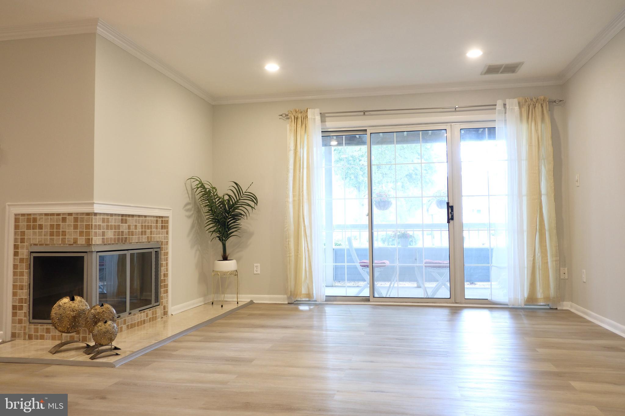307 Trinity Court, Unit 4 Princeton, NJ 08540 - Photo 8 of 39 a living room with wooden floor and a fireplace