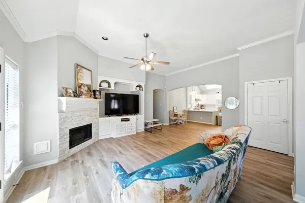 a living room with furniture a flat screen tv and a fireplace