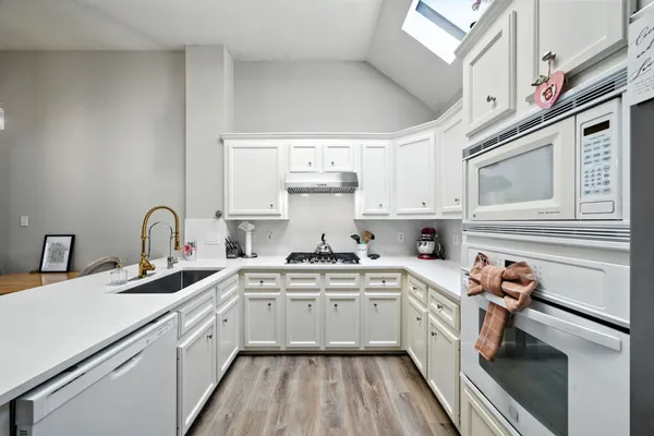 a kitchen with cabinets a sink and appliances