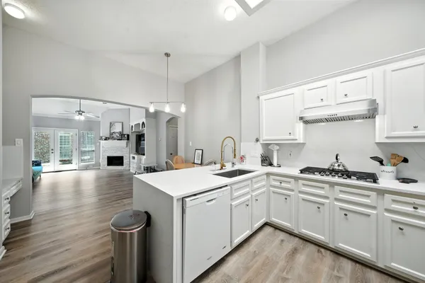 a kitchen with a sink stove and cabinets