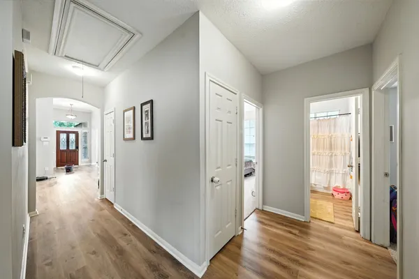 a view of a hallway with wooden floor